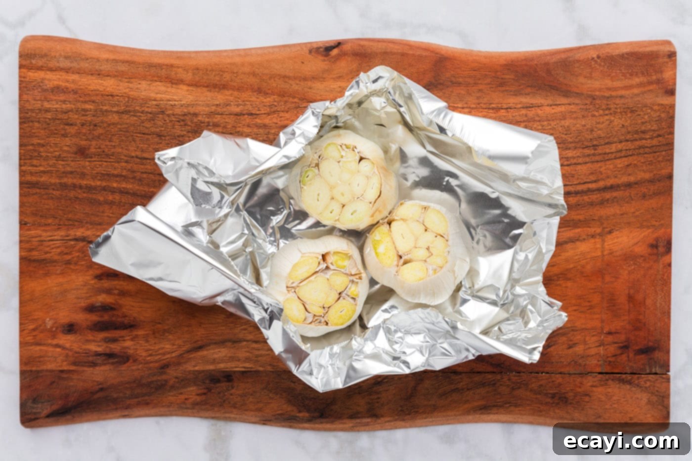 Roasting Garlic Made Easy 6 sliced whole bulbs of garlic in aluminum foil