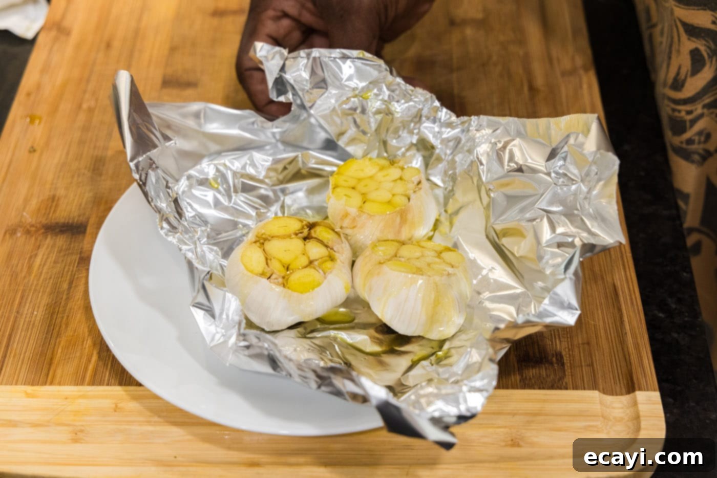 Roasting Garlic Made Easy 7 garlic bulbs in aluminum foil with olive oil