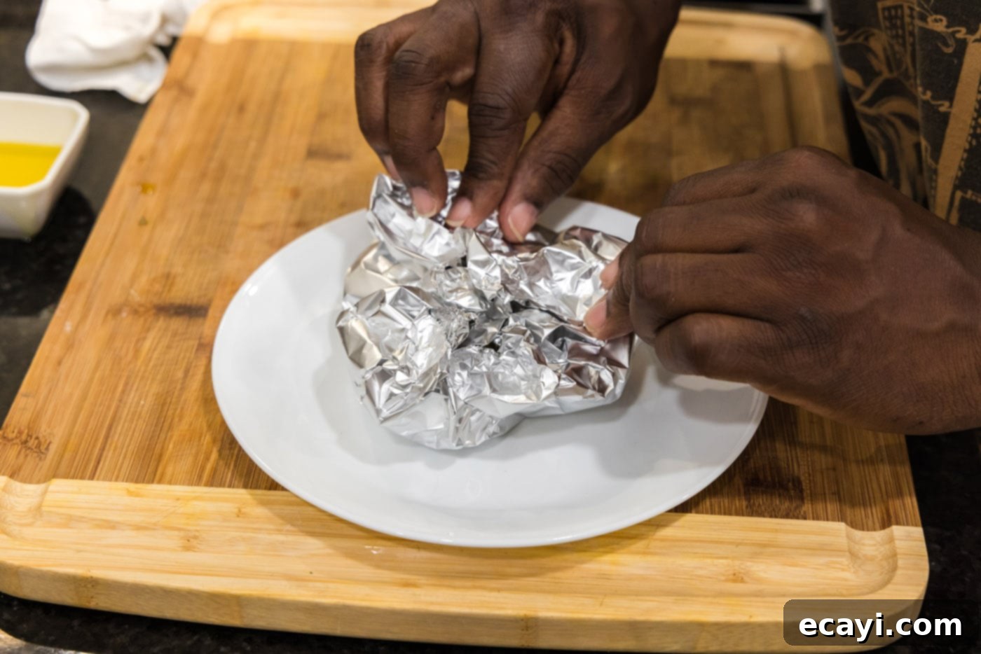 Roasting Garlic Made Easy 8 closing aluminum foil around garlic bulbs