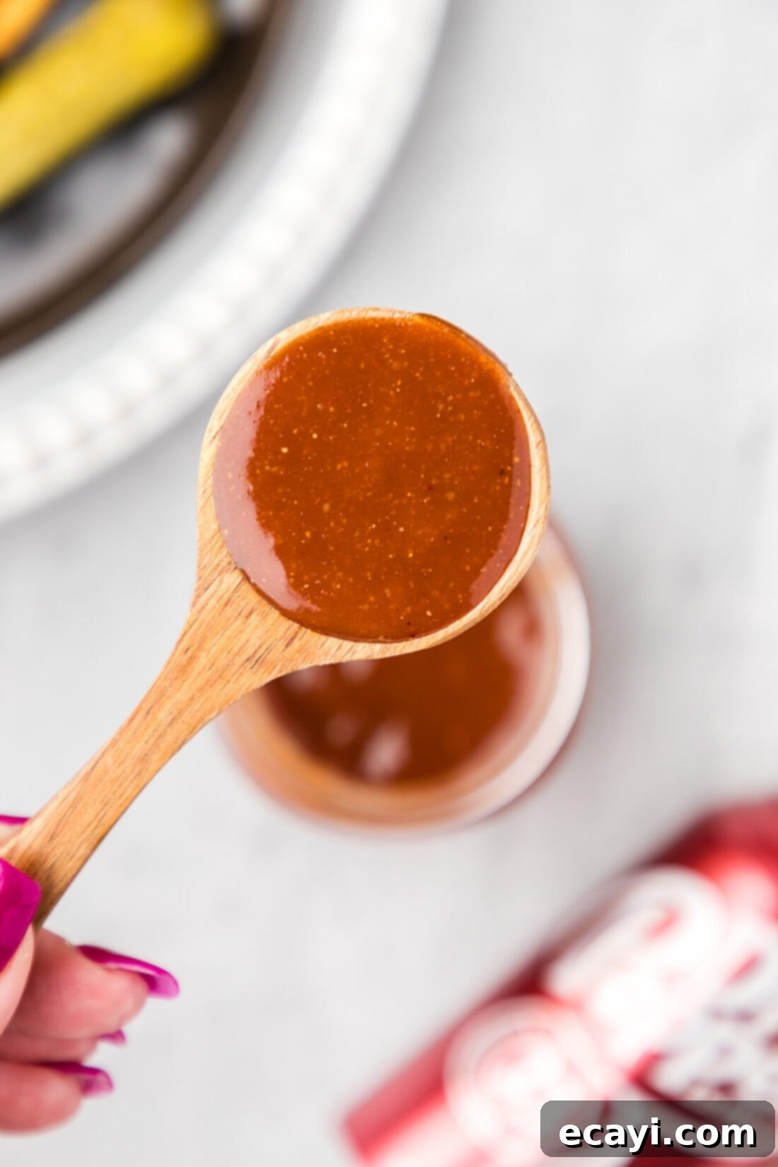 Dr Pepper Infused BBQ Sauce 11 Spoonful of Dr Pepper Barbecue Sauce held above a jar