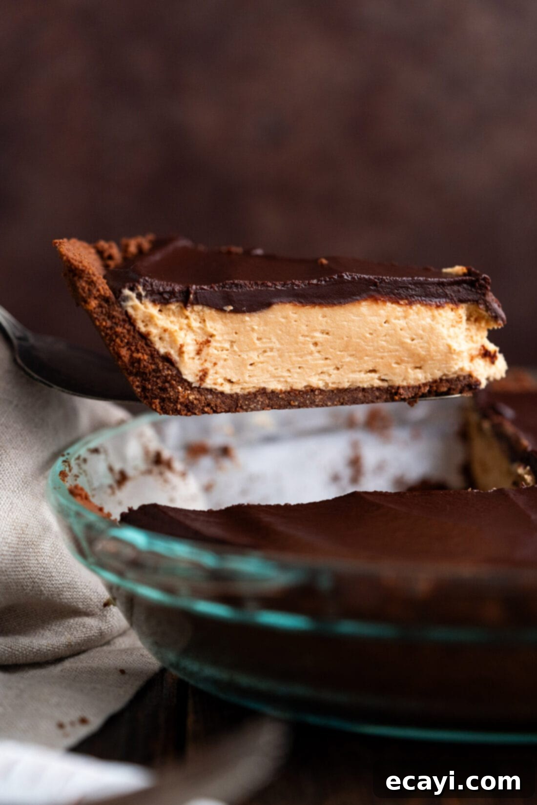 Decadent Peanut Butter Chocolate Dream 2 Slice of Chocolate Peanut Butter Pie being lifted out of the pie dish