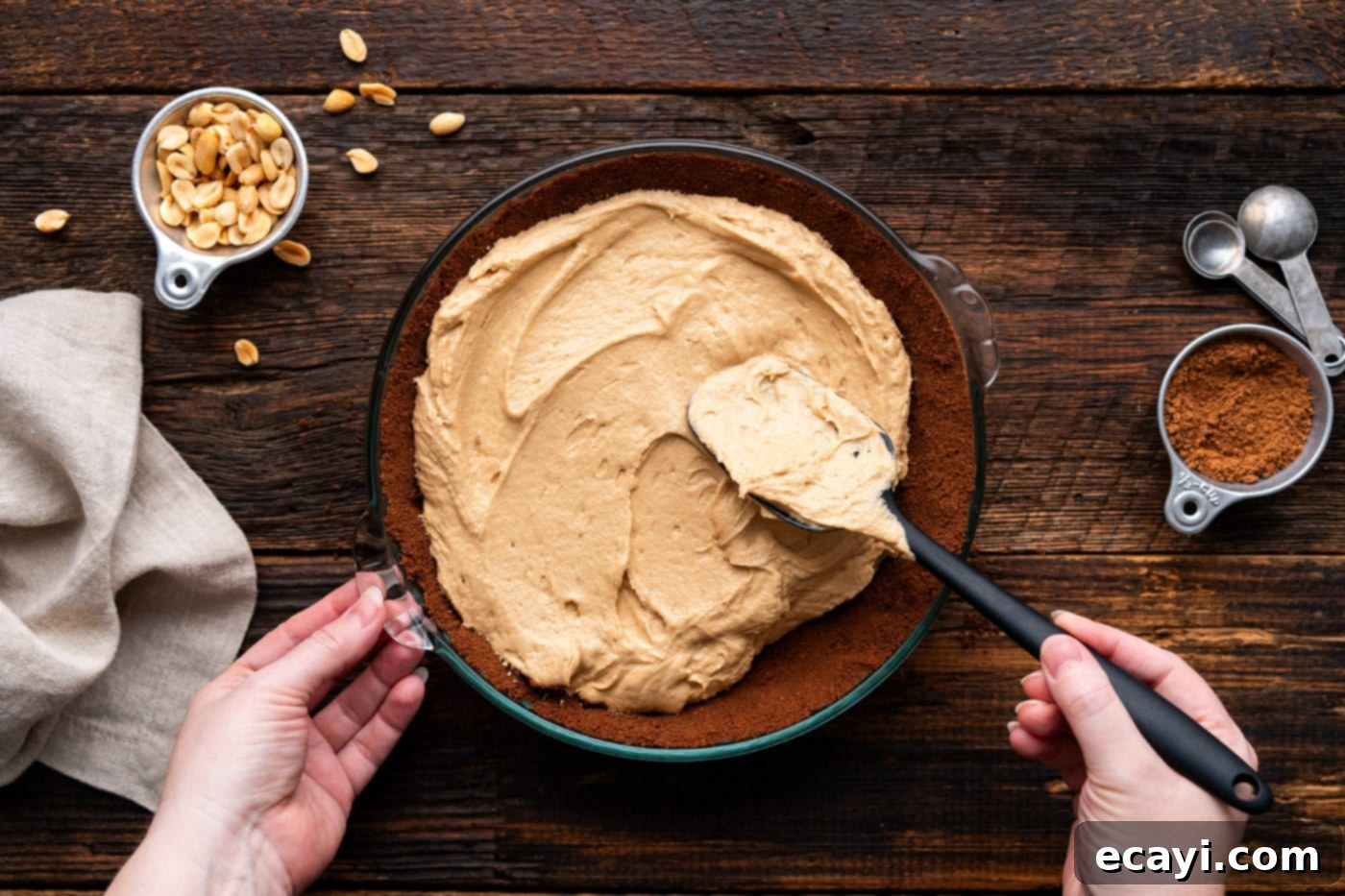 Decadent Peanut Butter Chocolate Dream 11 spreading peanut butter pie filling over chocolate graham crust