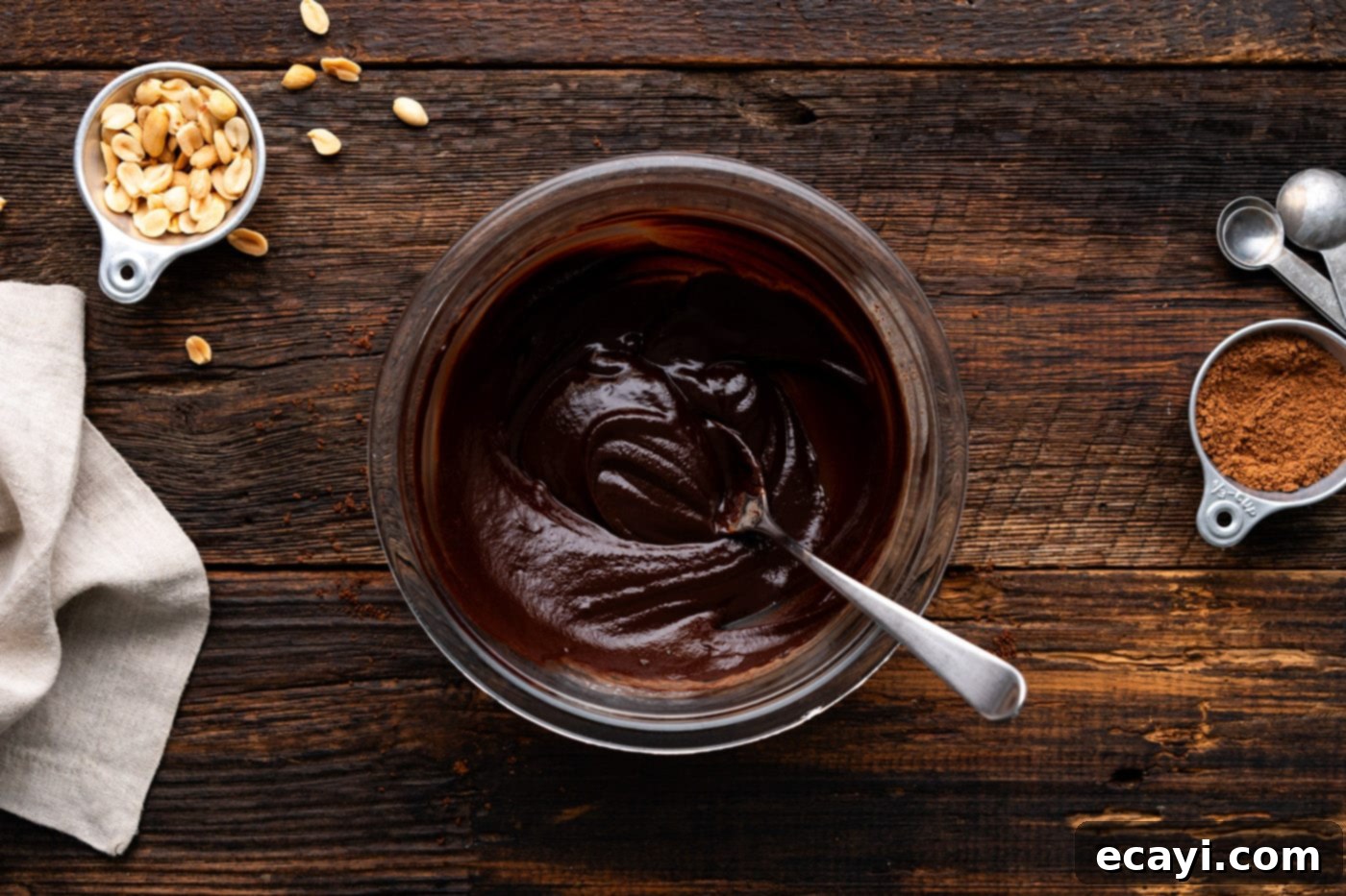 Decadent Peanut Butter Chocolate Dream 13 chocolate ganache in a mixing bowl with a spoon