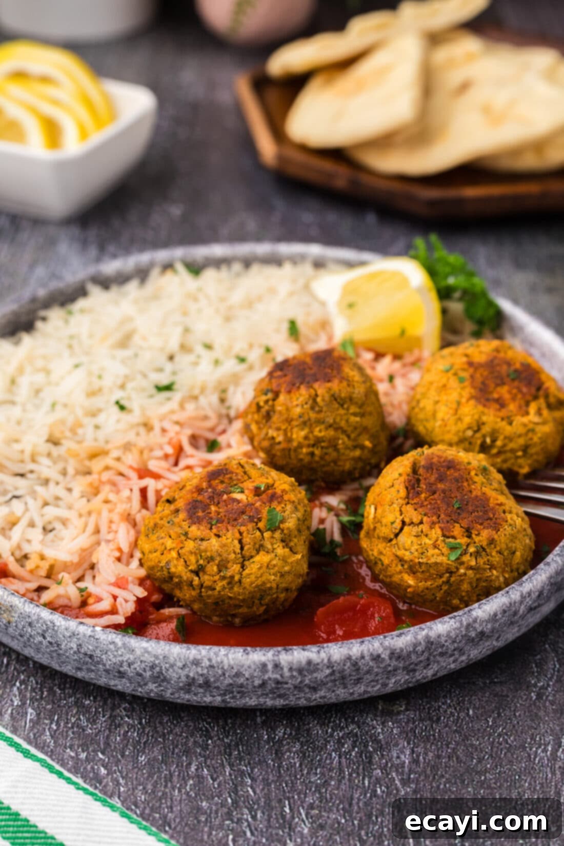 Hearty Lentil Meatballs 2 Lentil Meatballs on a plate with rice