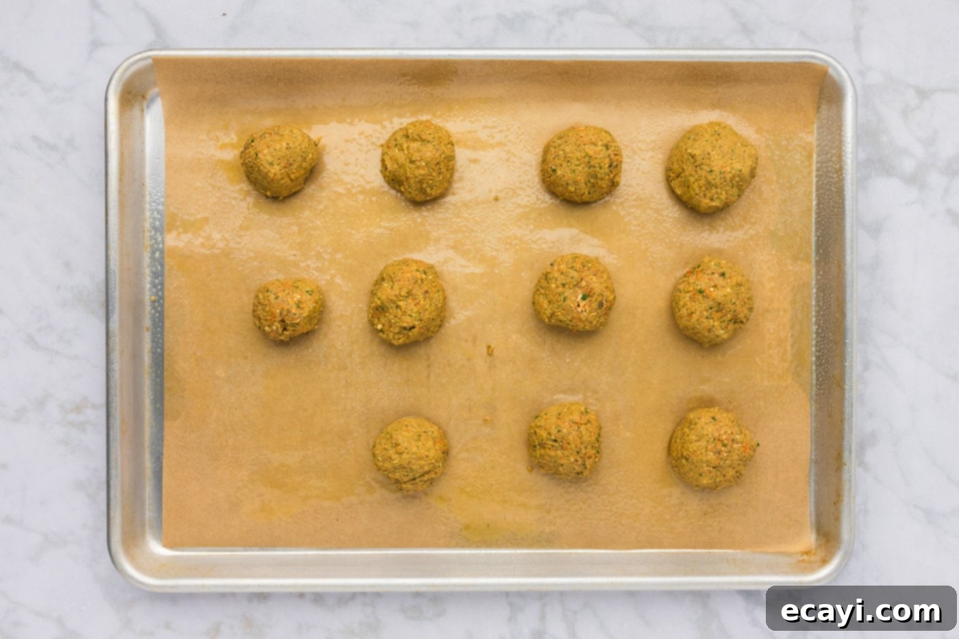 Hearty Lentil Meatballs 12 rolled lentil meatball dough on a baking sheet