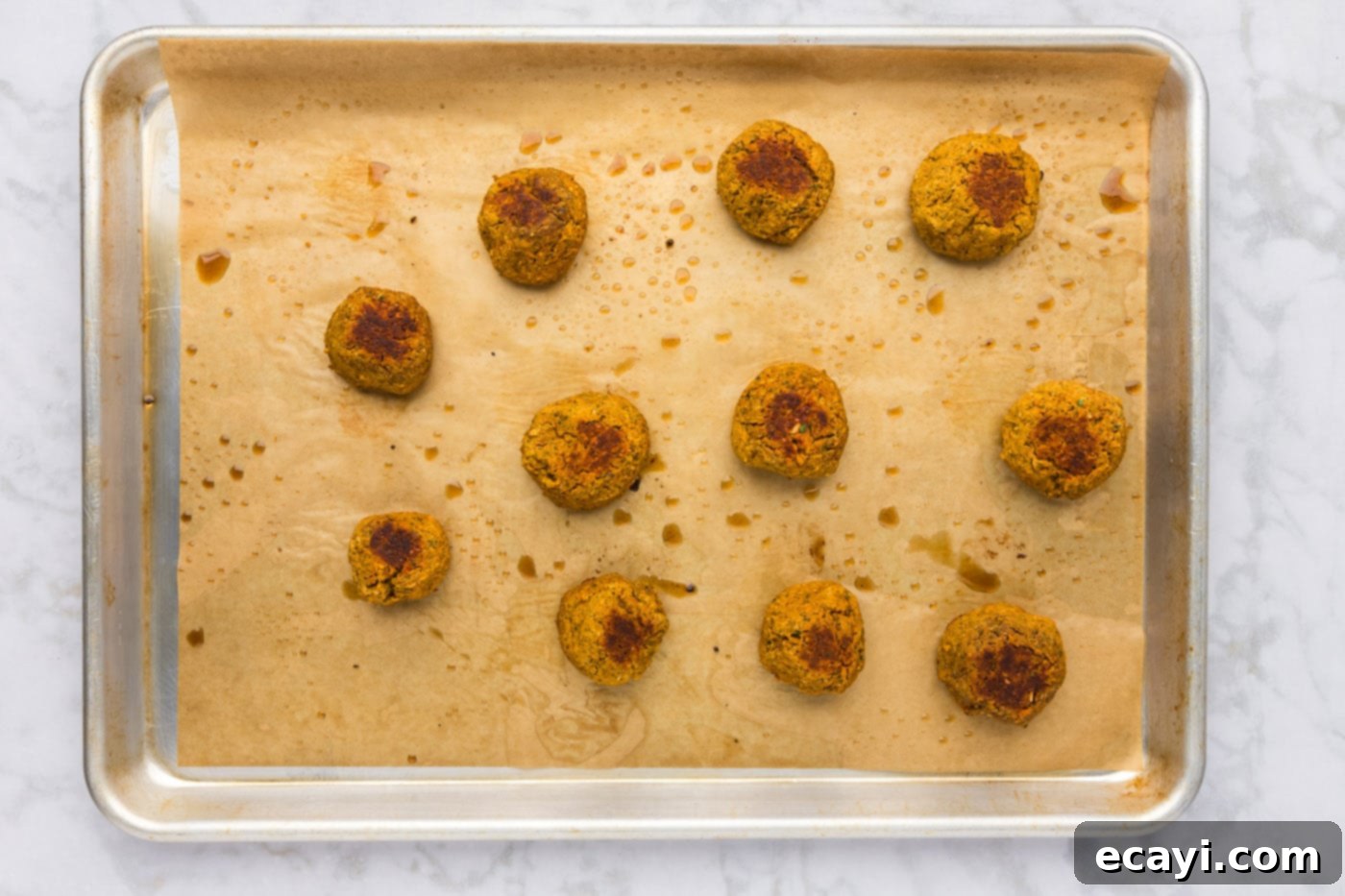 Hearty Lentil Meatballs 13 baked lentil meatballs on a cookie sheet