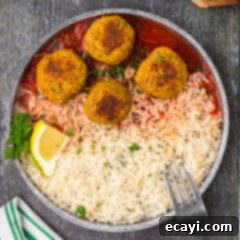Hearty Lentil Meatballs 15 Four Lentil Meatballs on a plate with rice and a fork