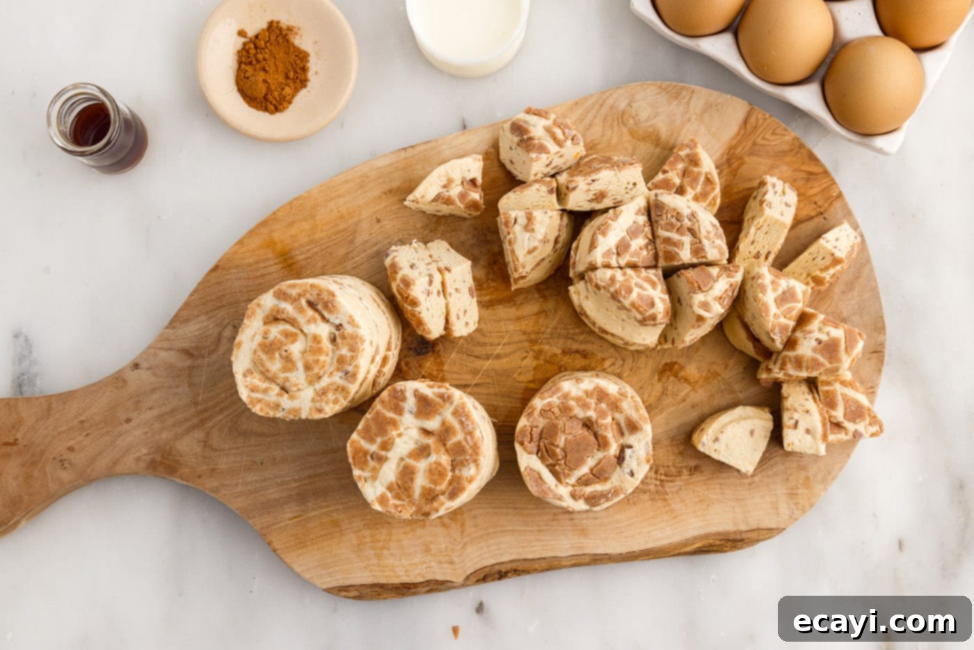 Gooey Cinnamon Brunch Bake 5 cinnamon rolls chopped on a cutting board, ready for the casserole
