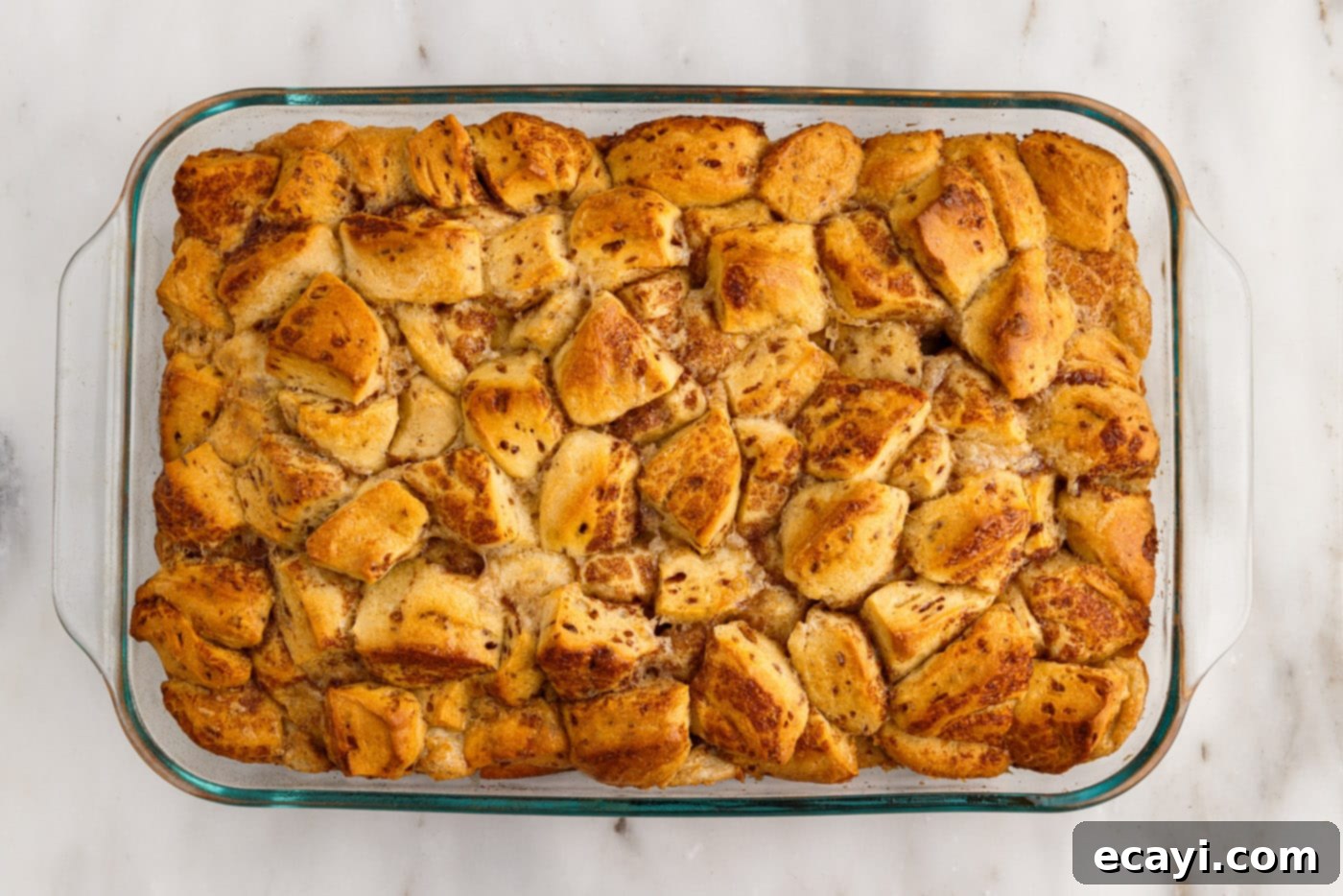 Gooey Cinnamon Brunch Bake 10 baked cinnamon roll casserole, golden brown and puffed
