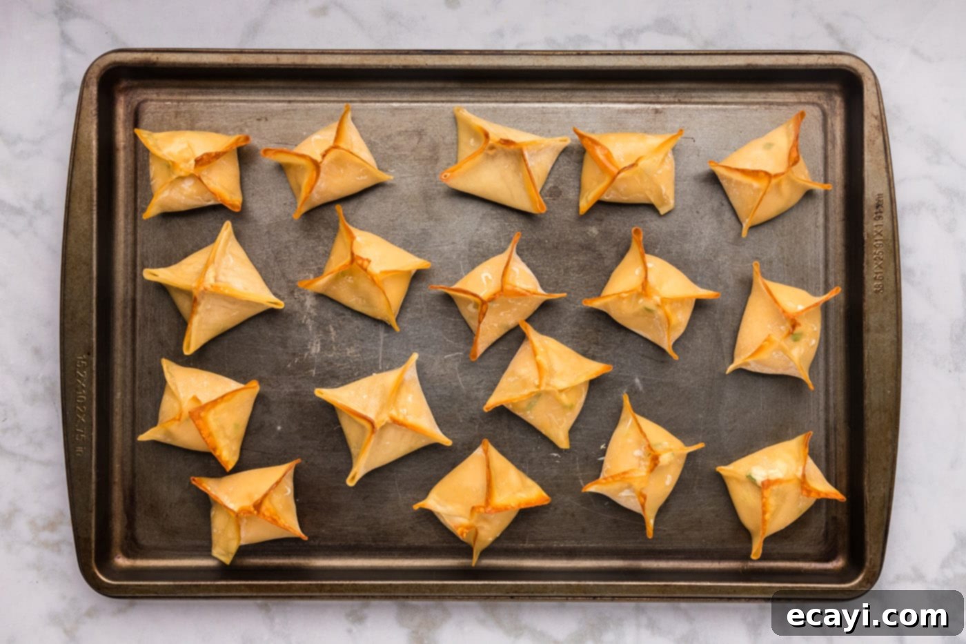 Golden Crab Cream Crisps 11 easy baked crab rangoon on a baking sheet