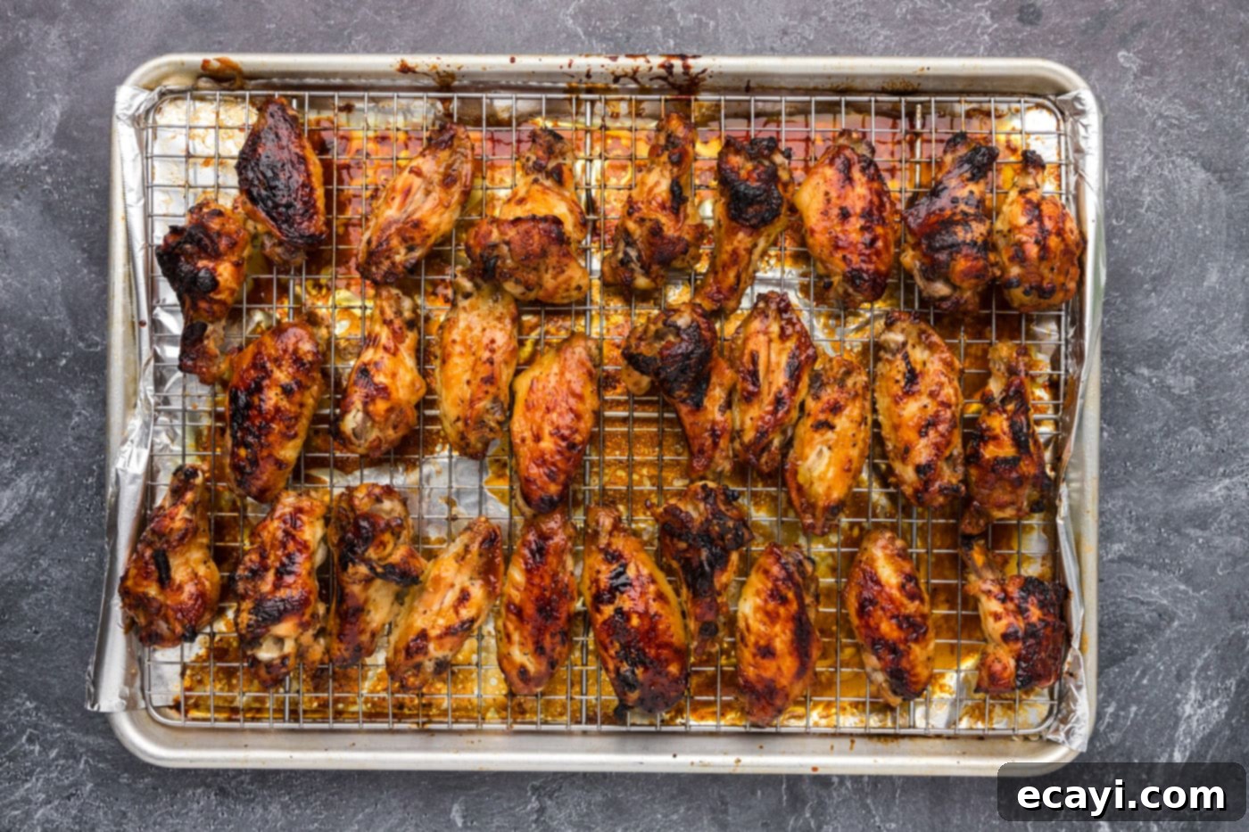 Sticky Honey Garlic Wings 11 honey garlic coated wings on a baking sheet