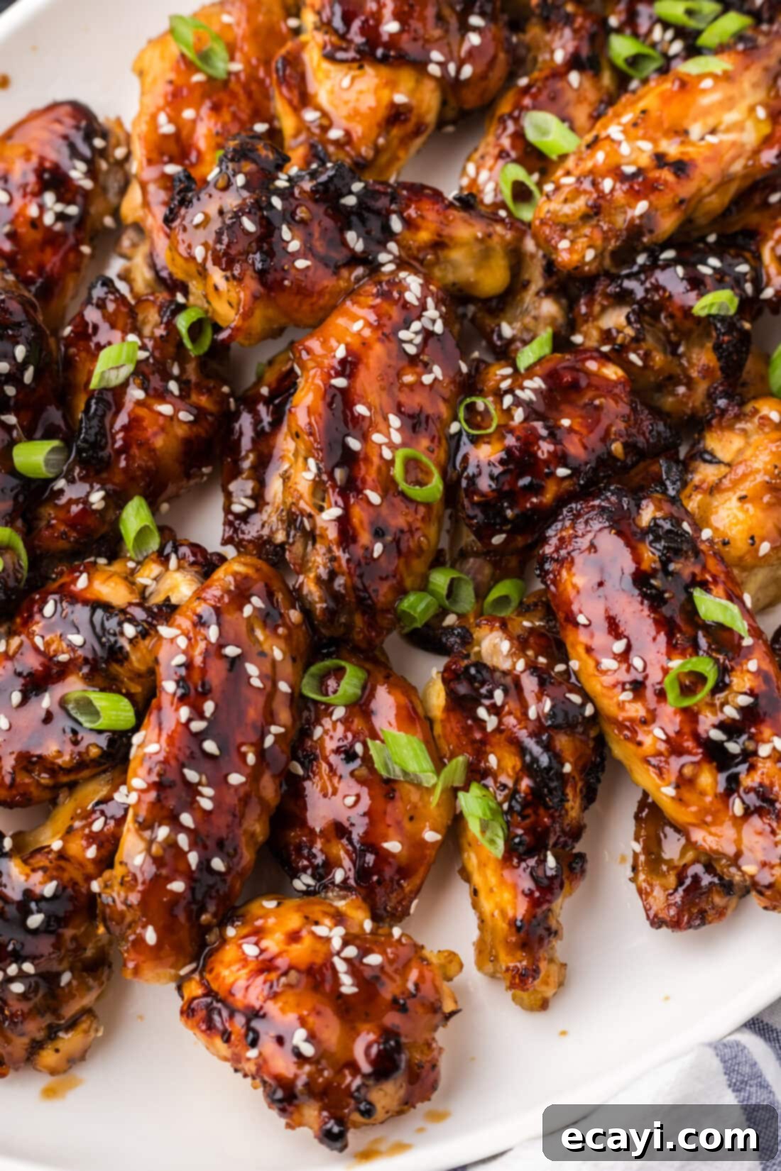 Sticky Honey Garlic Wings 12 Close up photo of a platter of Honey Garlic Chicken Wings