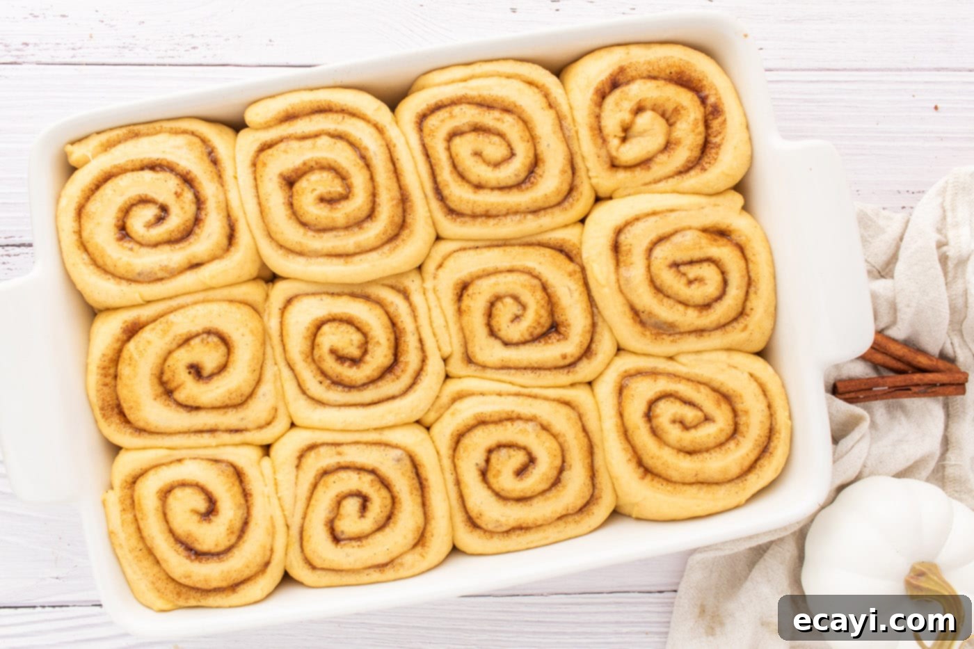 Golden Pumpkin Spiced Swirls 15 cinnamon roll dough in baking pan, having risen and doubled in size