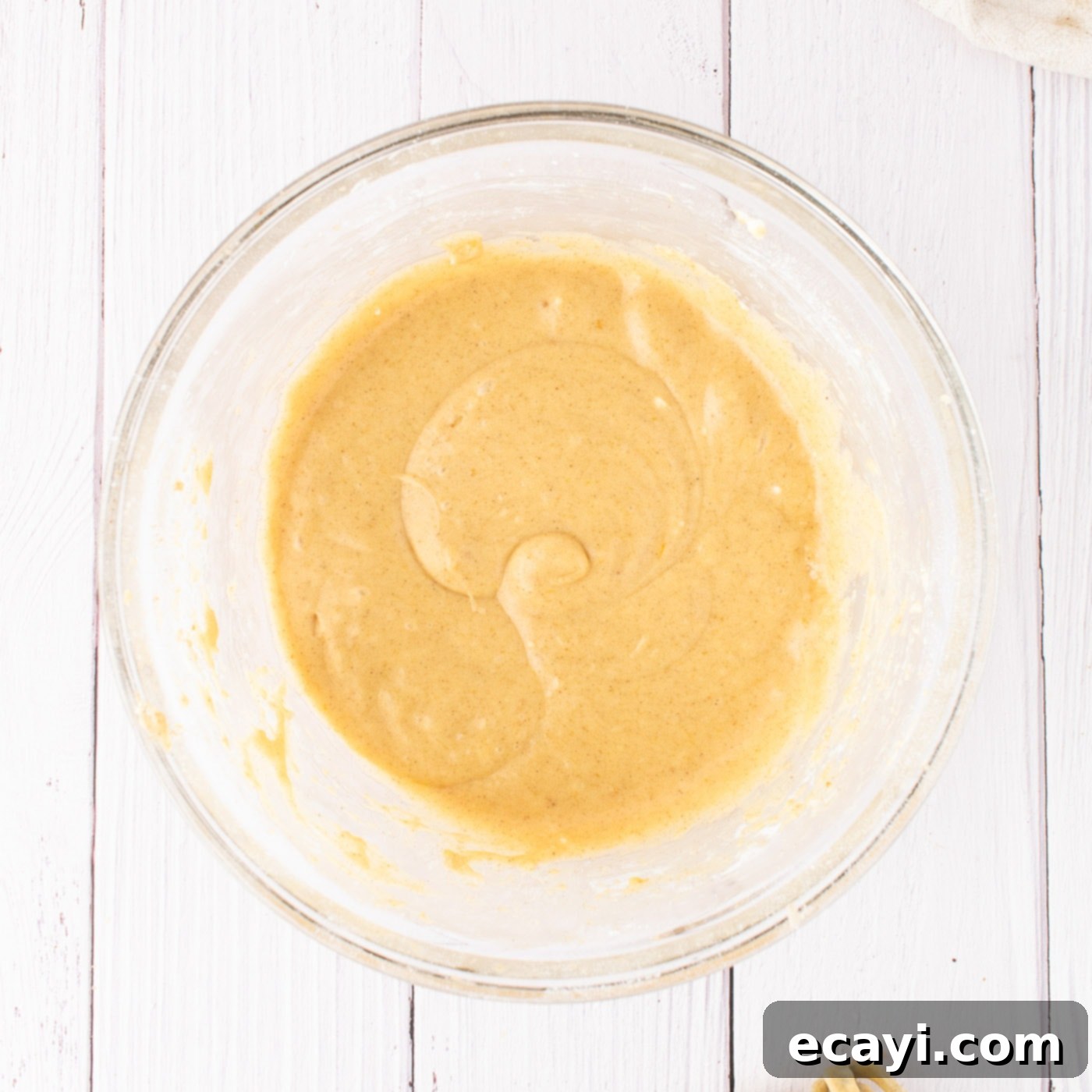 Golden Pumpkin Spiced Swirls 17 pumpkin cream cheese frosting in a bowl, smooth and creamy