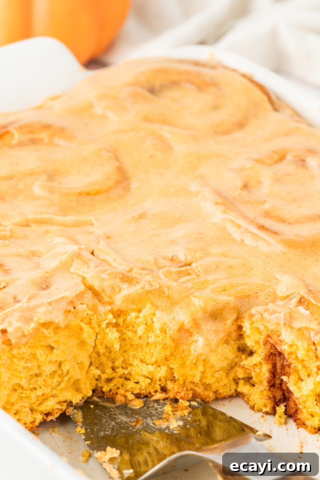 Golden Pumpkin Spiced Swirls 19 Close up photo of a pan of Pumpkin Cinnamon Rolls, showing their golden brown tops and gooey centers