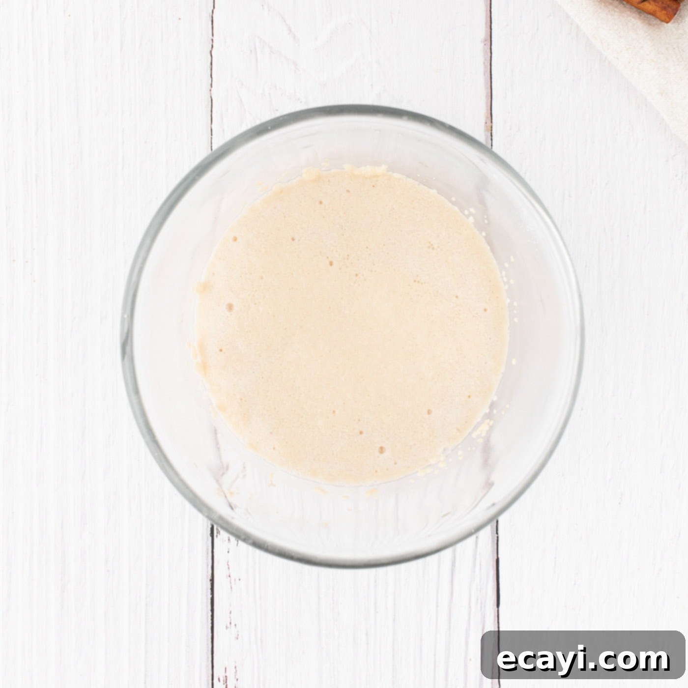 Golden Pumpkin Spiced Swirls 5 active dry yeast in a bowl with sugar and warm water, showing foam on top