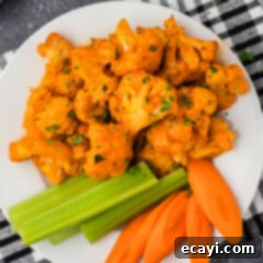 Buffalo Cauliflower Bites 15 Buffalo Cauliflower on a plate with celery and carrots
