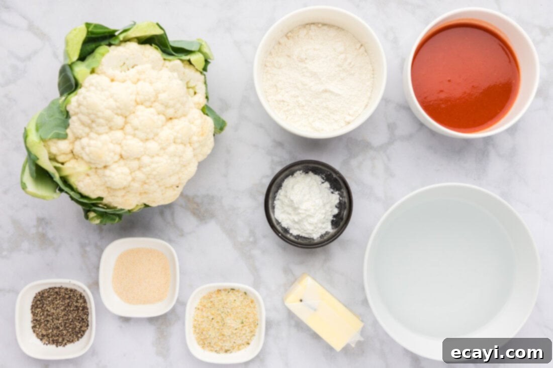 Buffalo Cauliflower Bites 4 Ingredients for Buffalo Cauliflower, including cauliflower head, flour, hot sauce, butter, and seasonings