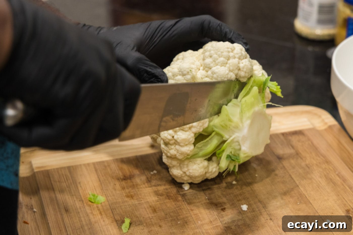 Buffalo Cauliflower Bites 5 Slicing cauliflower with a chefs knife