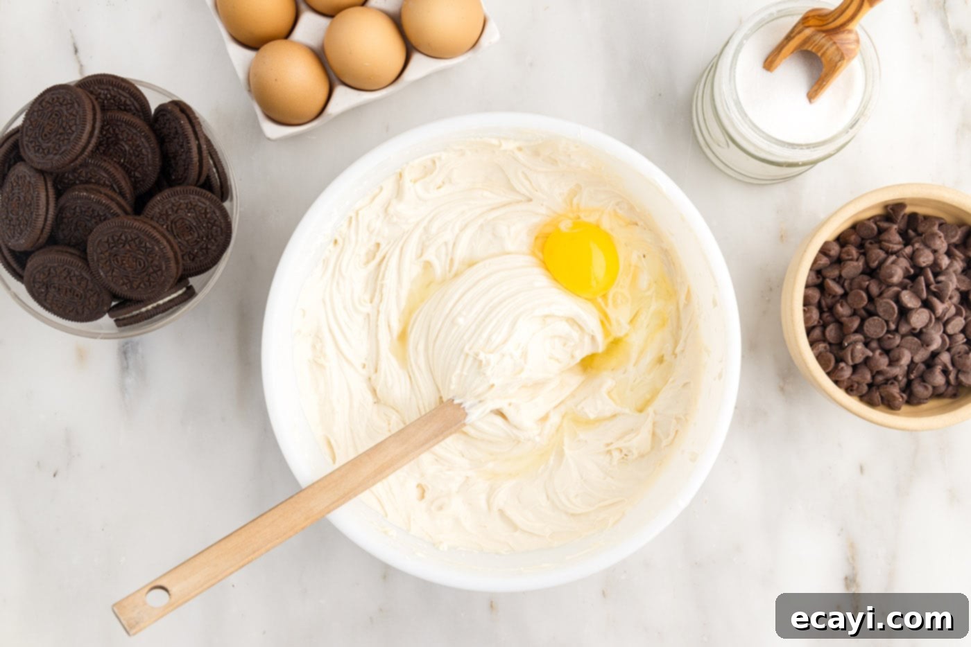 Irresistible Baileys Cheesecake 11 adding an egg to cheesecake batter