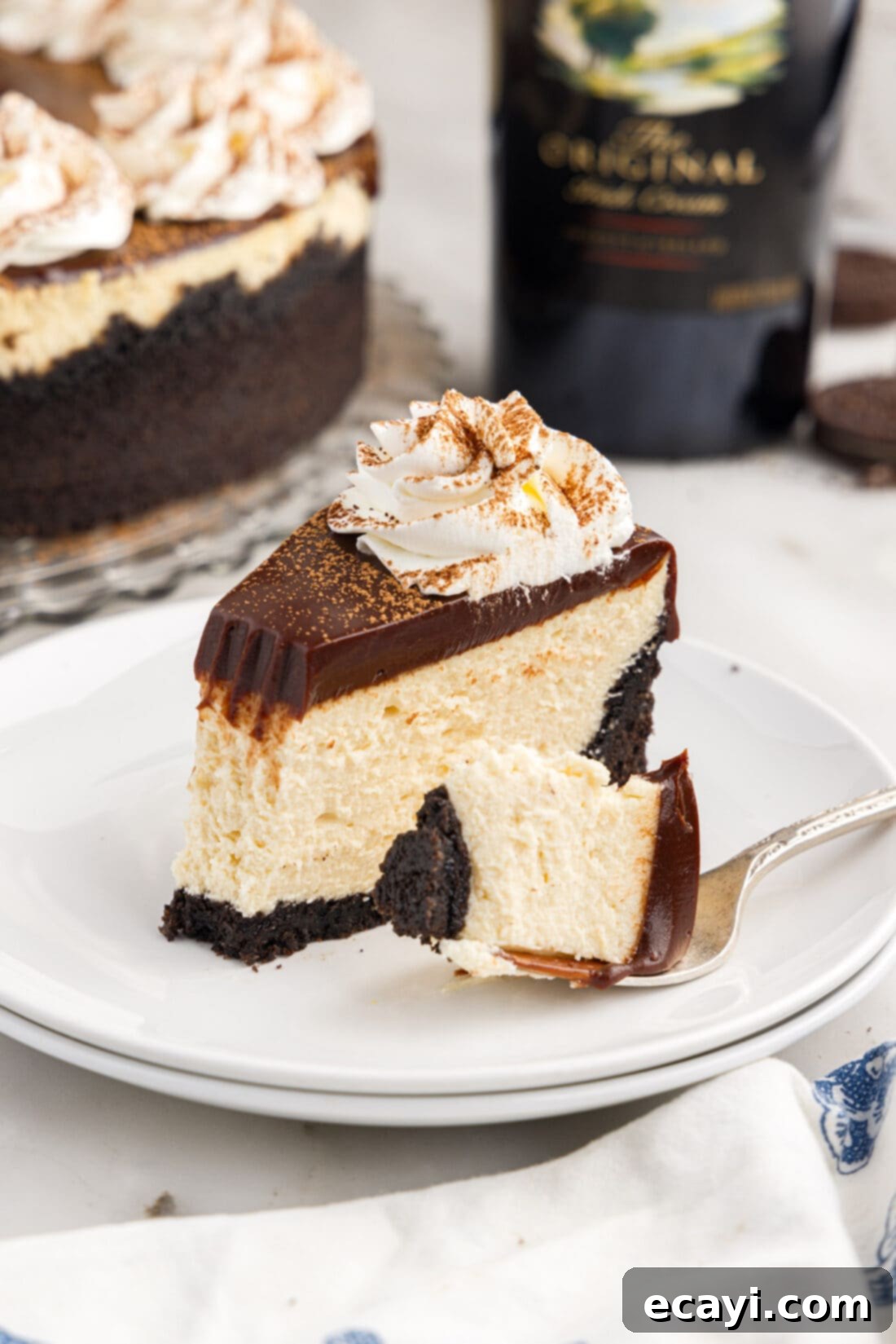 Irresistible Baileys Cheesecake 3 Slice of Baileys Cheesecake on a plate with a bite removed