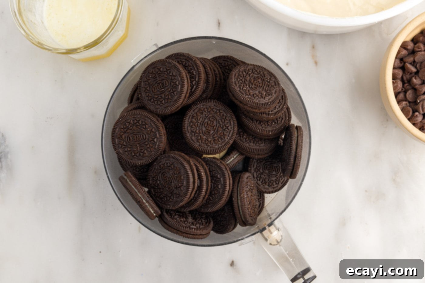 Irresistible Baileys Cheesecake 5 Oreos in a food processor bowl