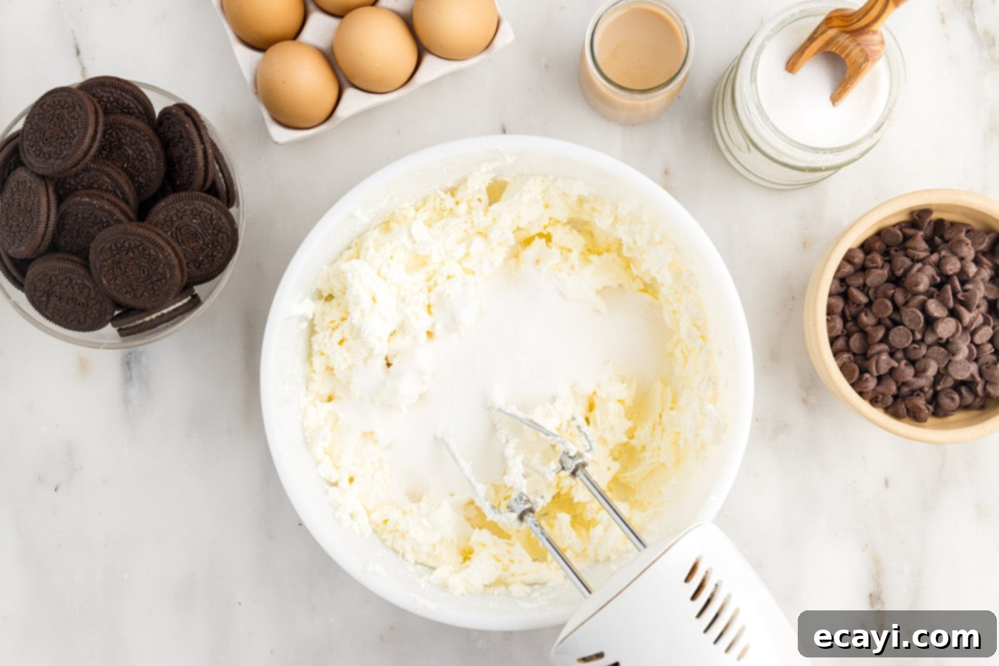 Irresistible Baileys Cheesecake 8 blending cream cheese with sugar with a mixer