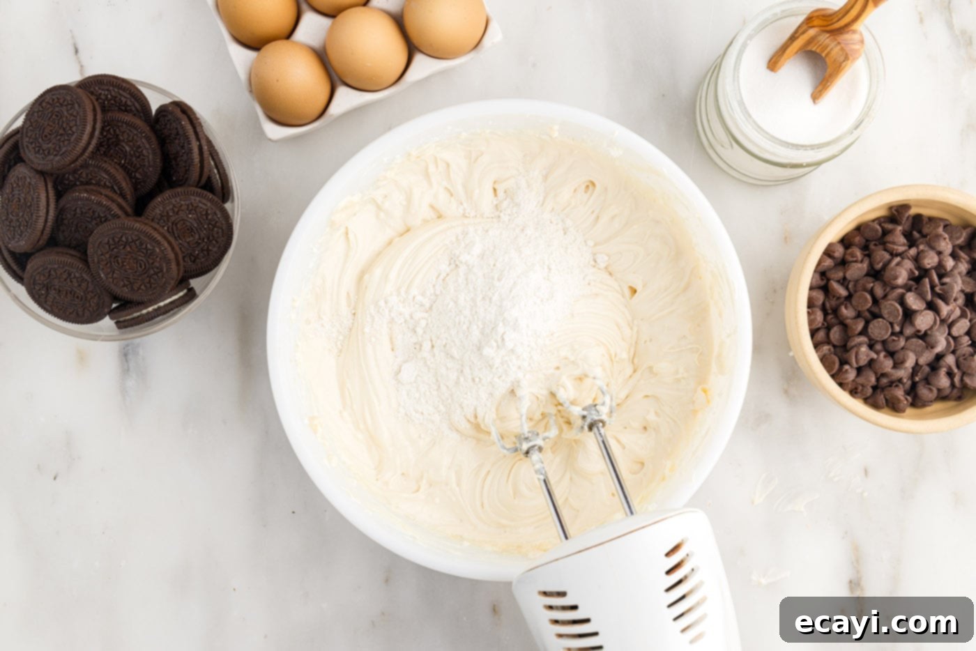Irresistible Baileys Cheesecake 9 adding flour to cheesecake mixture