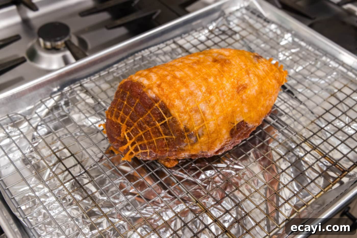 Succulent Lamb Leg Roast 7 leg of lamb on a wire rack over a baking sheet