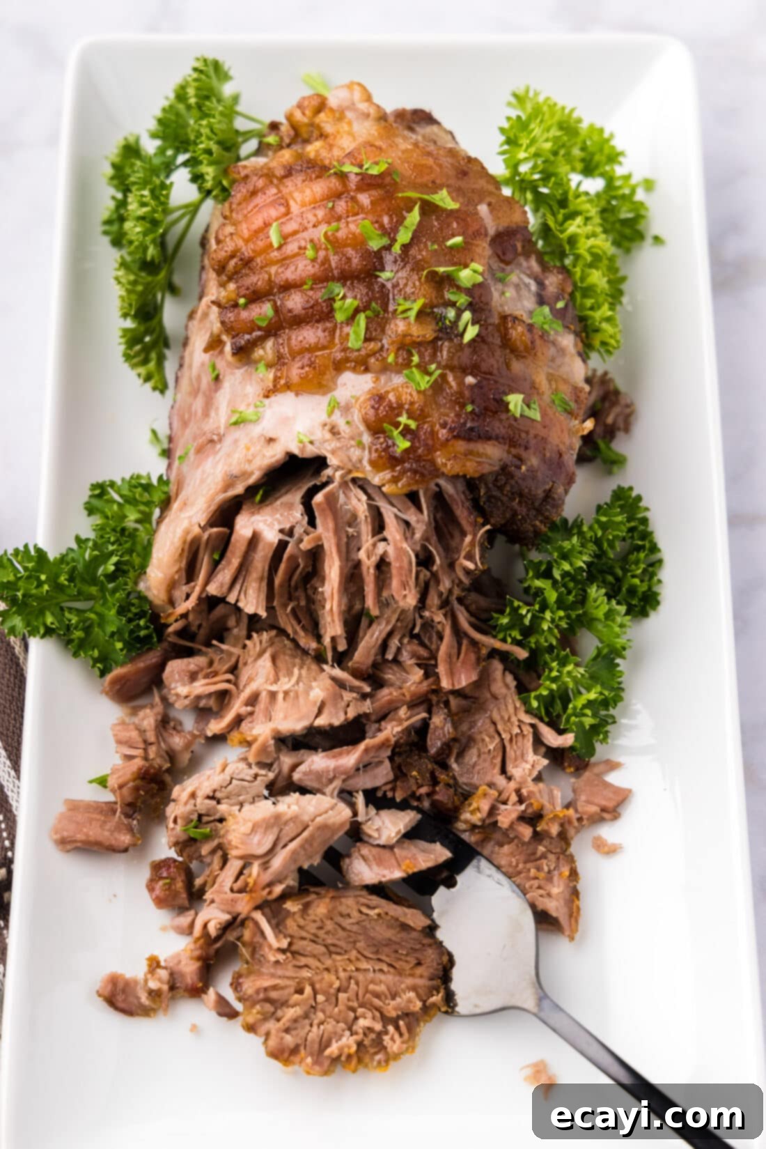 Succulent Lamb Leg Roast 9 Leg of Lamb on a platter half shredded