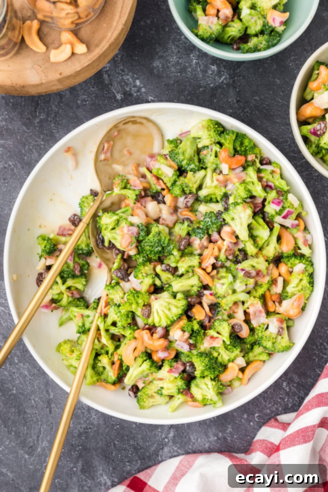 Garden Cashew Crunch 3 Bowl of Broccoli Cashew Salad with two spoons in it