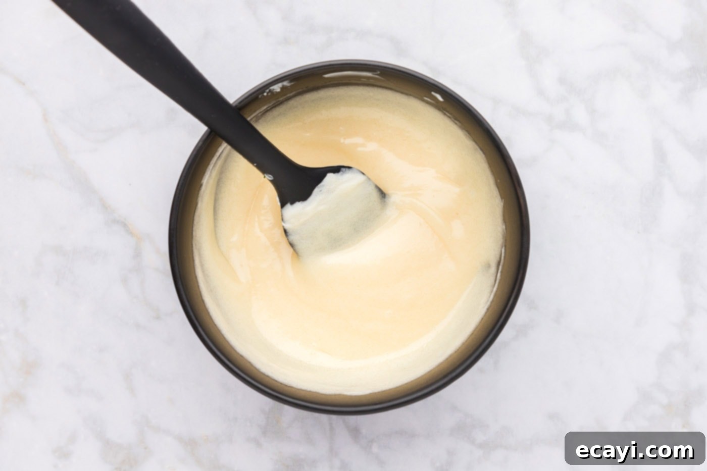 Garden Cashew Crunch 6 mayo dressing mixed in a bowl with a rubber spatula