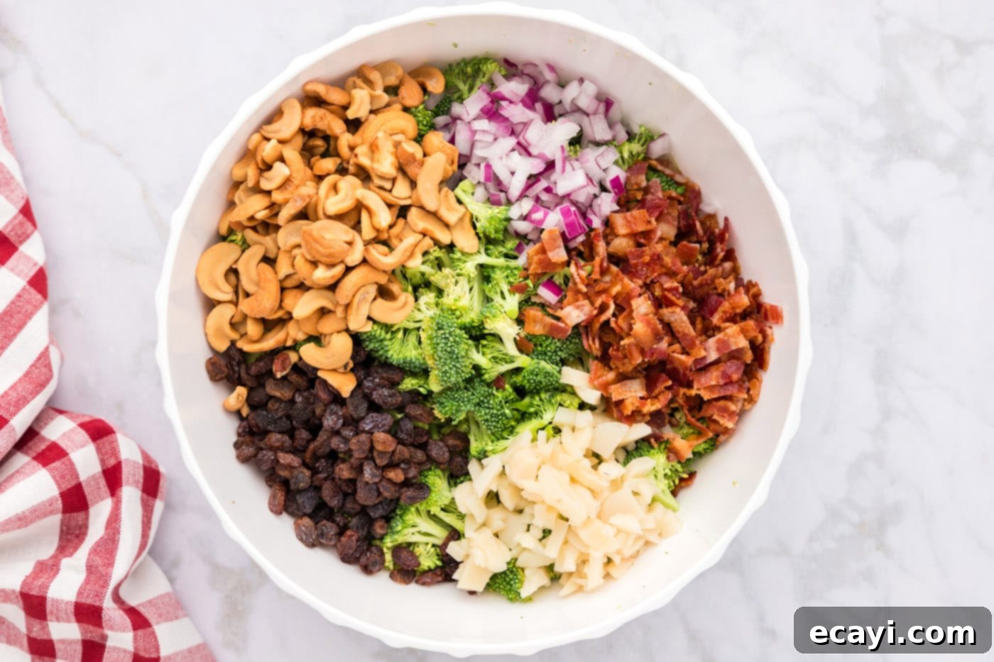 Garden Cashew Crunch 7 bacon, raisins, cashews, water chestnuts, and onion with broccoli in a bowl