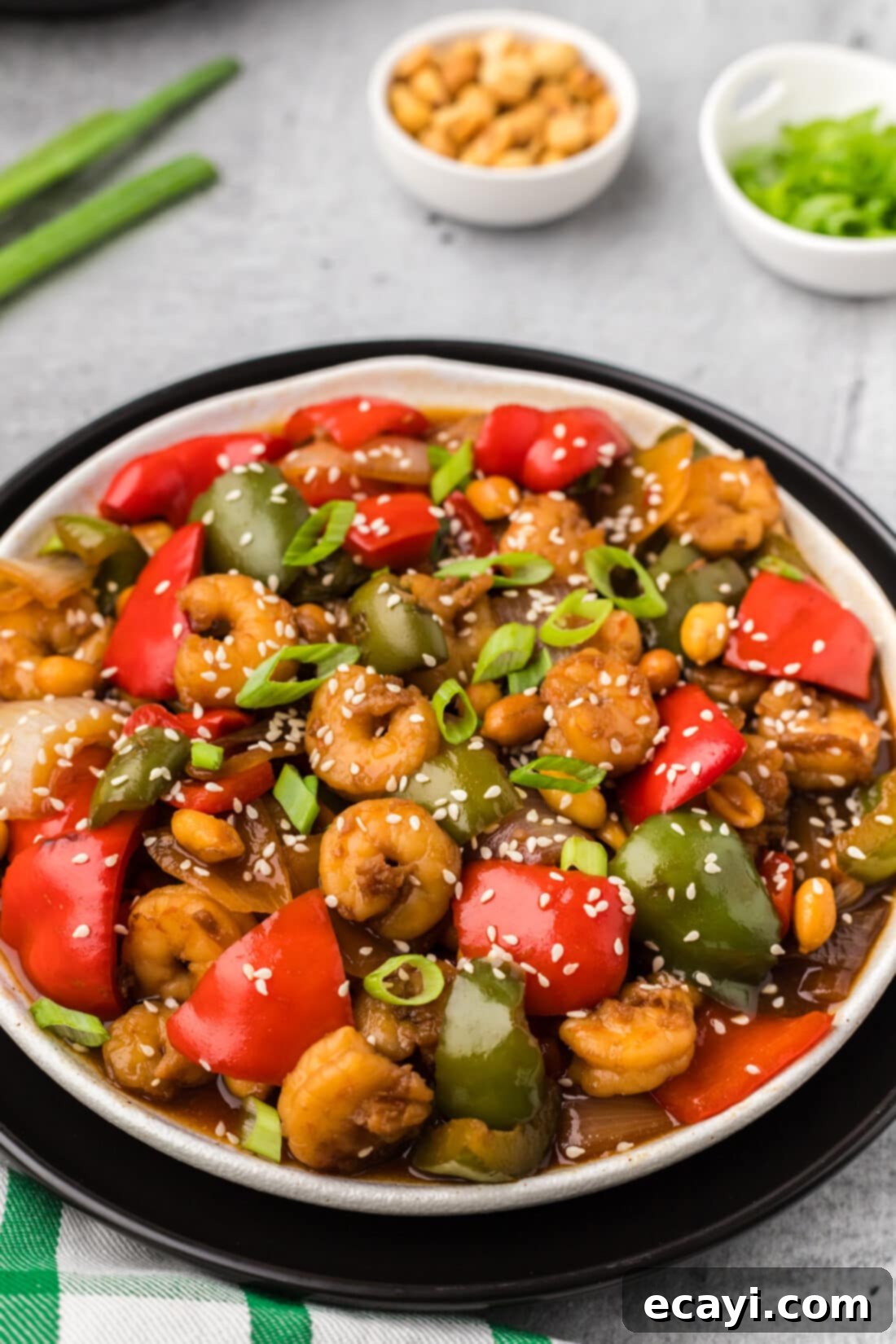 Fiery Wok Shrimp 14 Plate of Kung Pao Shrimp served over rice, garnished with green onions