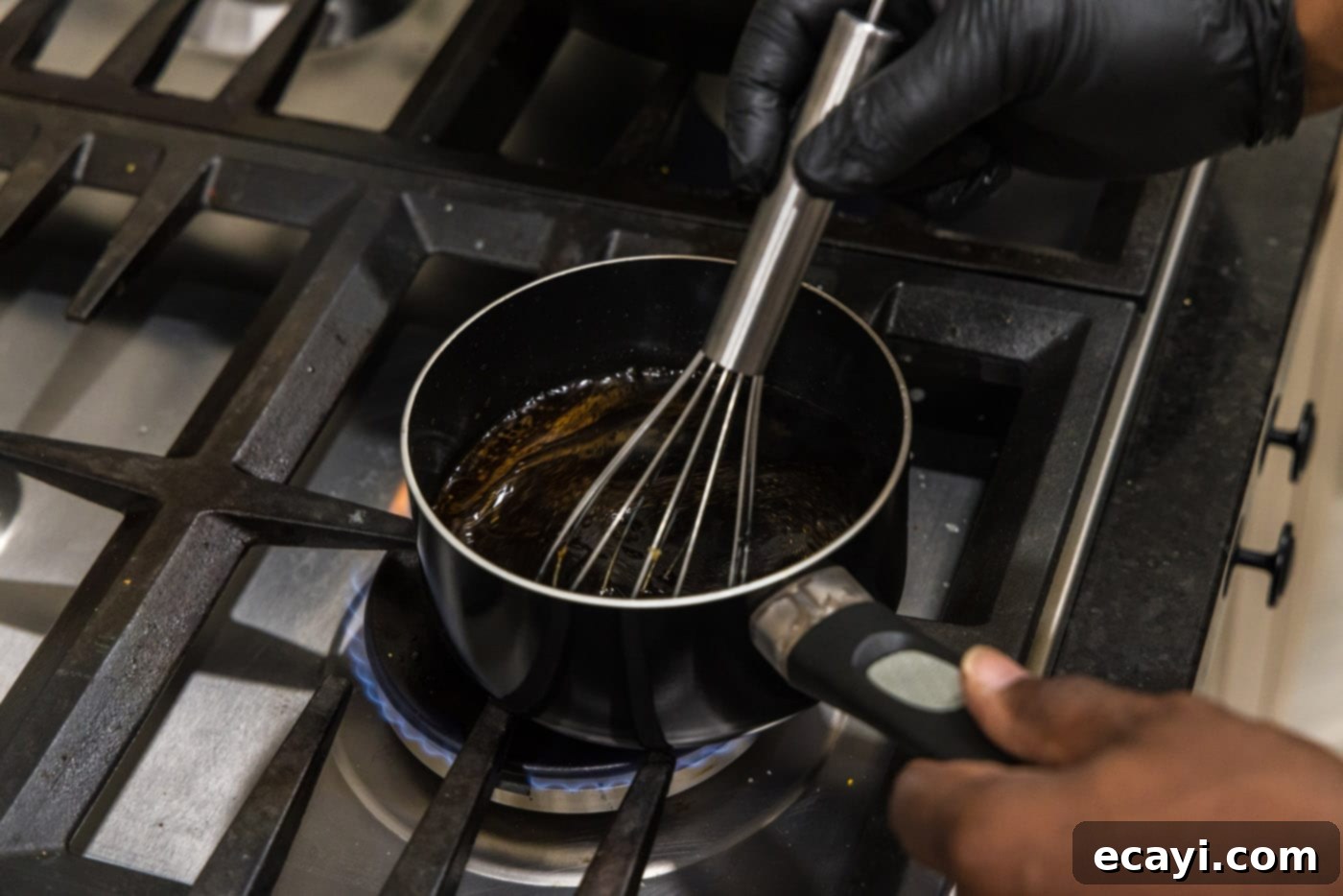 Fiery Wok Shrimp 8 whisking kung pao sauce in a saucepan to thicken