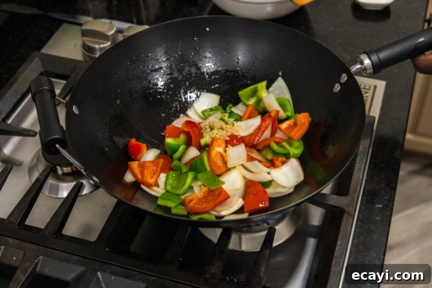 Fiery Wok Shrimp 10 stir frying onion and bell peppers in a wok