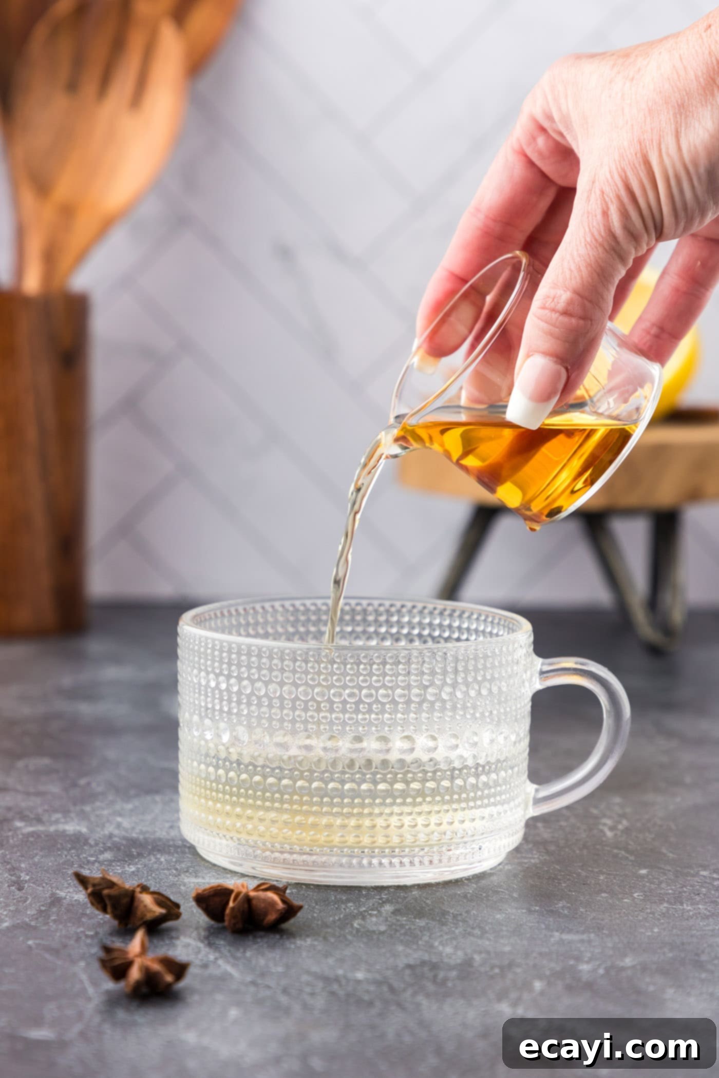 Cozy Comfort Brew 5 pouring bourbon into mug with water