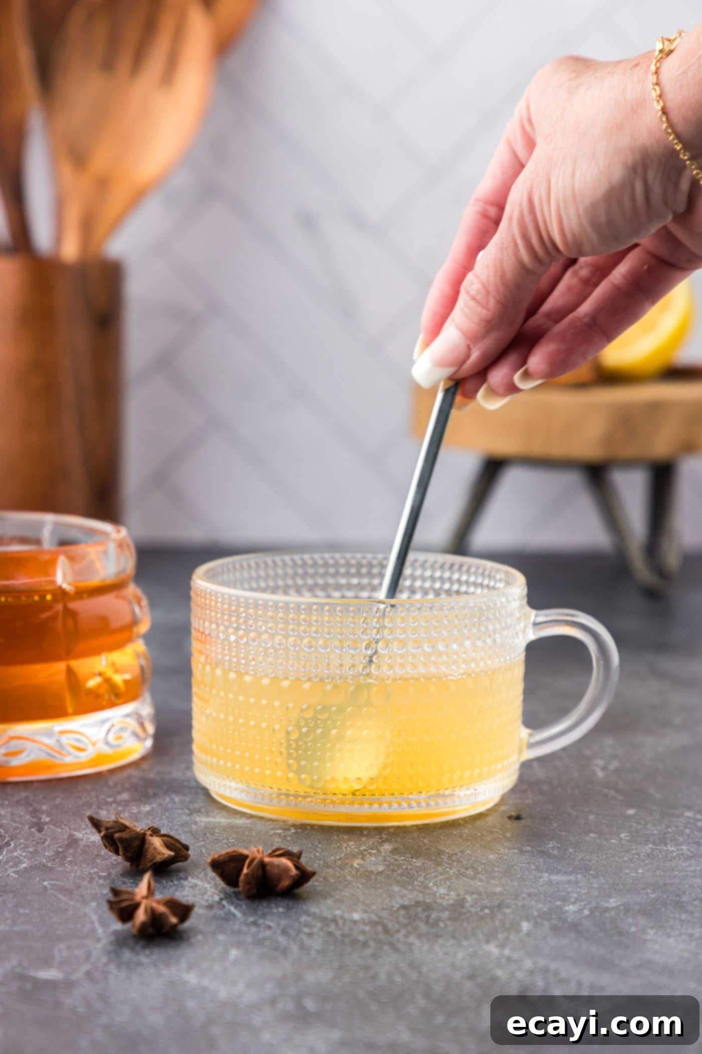 Cozy Comfort Brew 8 stirring hot toddy with a spoon