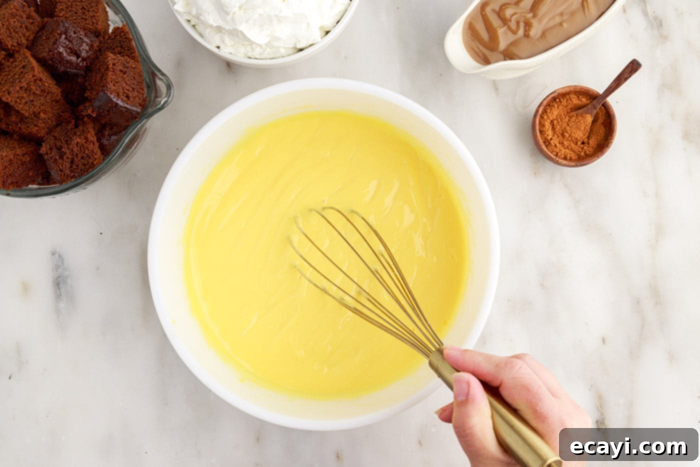 Gingerbread Layered Delight 6 Whisking instant vanilla pudding vigorously in a bowl to achieve a smooth, thick consistency