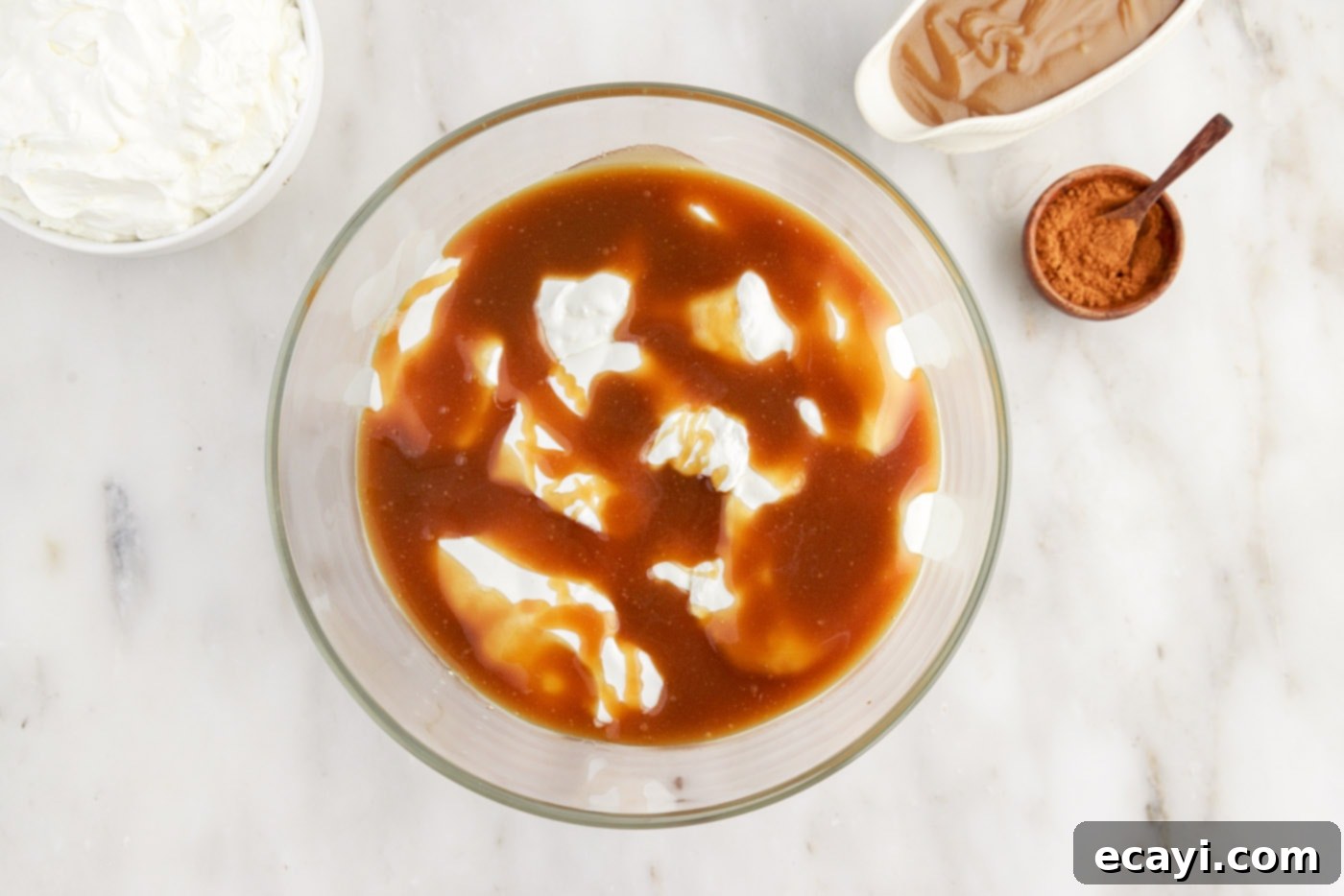 Gingerbread Layered Delight 10 A layer of glistening caramel sauce being drizzled over the whipped cream in the trifle