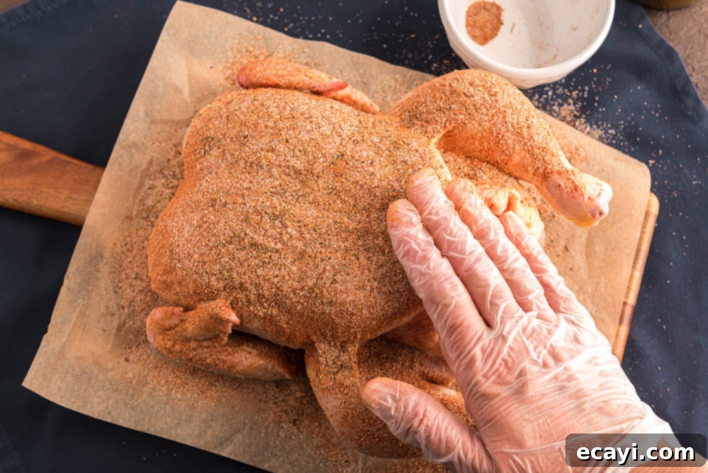 Slow Roasted Caramelized Chicken 5 rubbing whole chicken with seasoning
