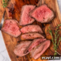 Perfect Air Fryer Roast Beef 9 Overhead photo of Air Fryer Roast Beef slices, showcasing a perfect medium-rare doneness and beautiful presentation.
