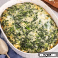 Savory Spinach Cloud 12 Close up photo of a Spinach Souffle, baked to a golden perfection, showcasing its fluffy and cheesy texture.