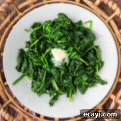 Perfectly Steamed Spinach 9 Perfectly Steamed Spinach on a plate with a pat of butter, ready to be served