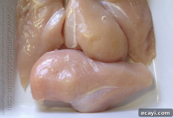 Golden-Crisp Oven Chicken Breasts 5 A close up photo of raw boneless, skinless chicken breasts ready for preparation.