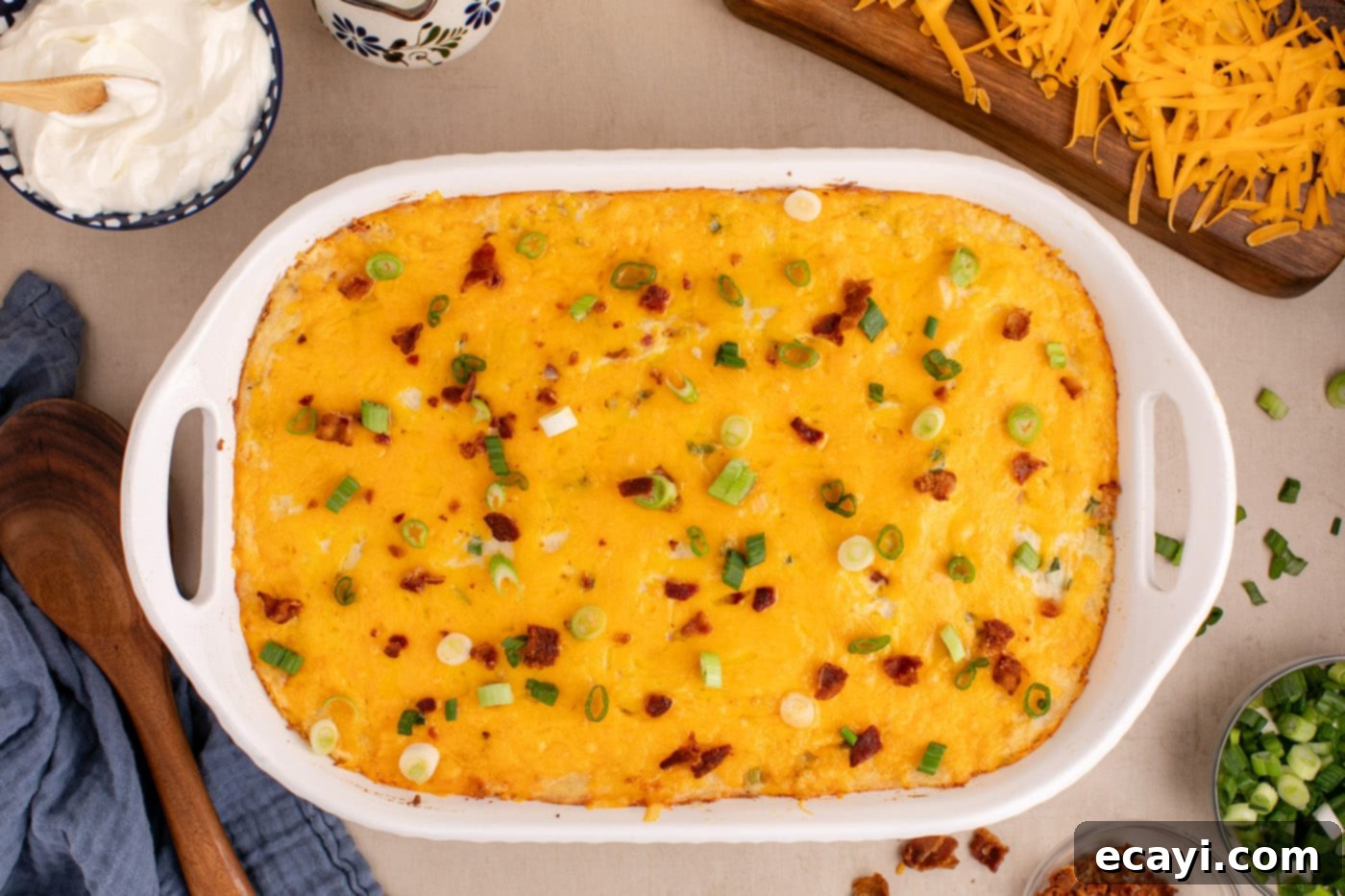 Loaded Cheesy Potato Casserole 13 freshly baked twice baked potato casserole garnished with crumbled bacon and sliced green onions, ready to serve