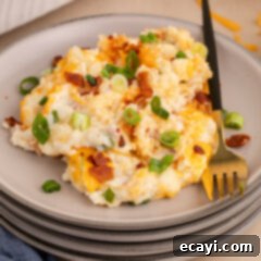 Loaded Cheesy Potato Casserole 15 Twice Baked Potato Casserole on a plate, garnished with green onions and bacon