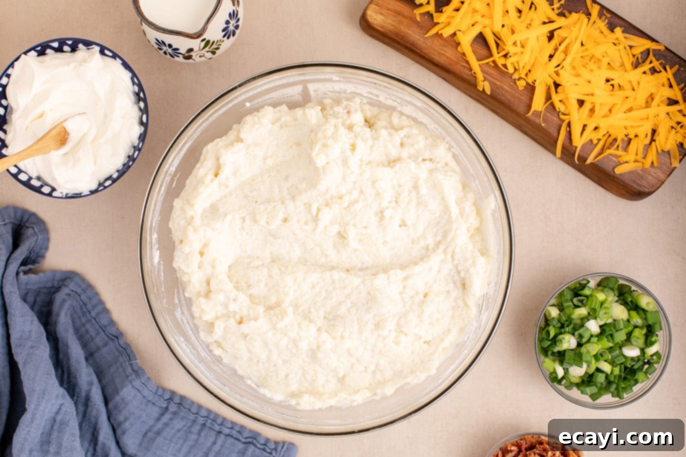 Loaded Cheesy Potato Casserole 8 the creamy and well-mixed twice baked potato filling in a bowl, ready for additions