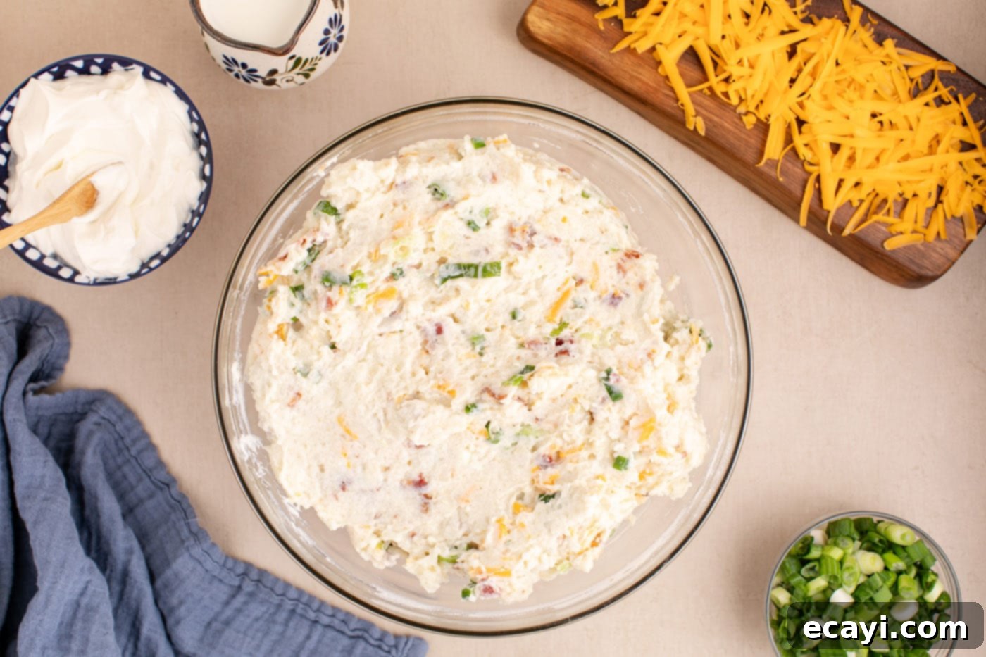 Loaded Cheesy Potato Casserole 10 the complete twice baked potato casserole filling, with all ingredients mixed in, resting in a bowl