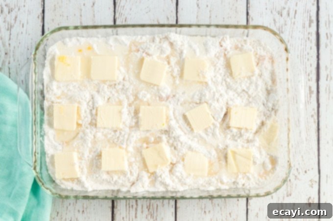 Effortless Peach Cobbler Bake 7 peach dump cake with butter pats on top